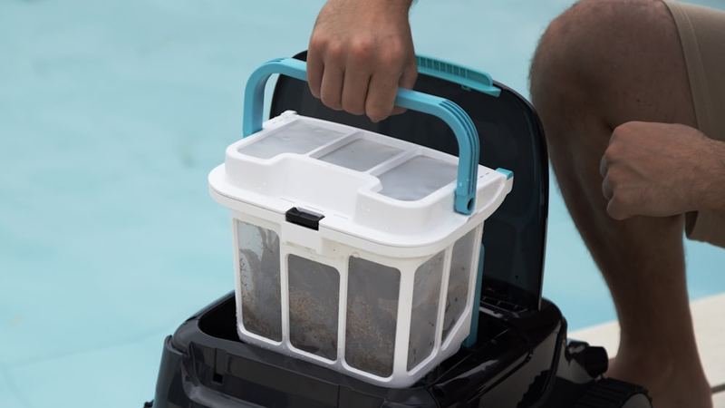 Pool filter housing and equipment beside a pool.