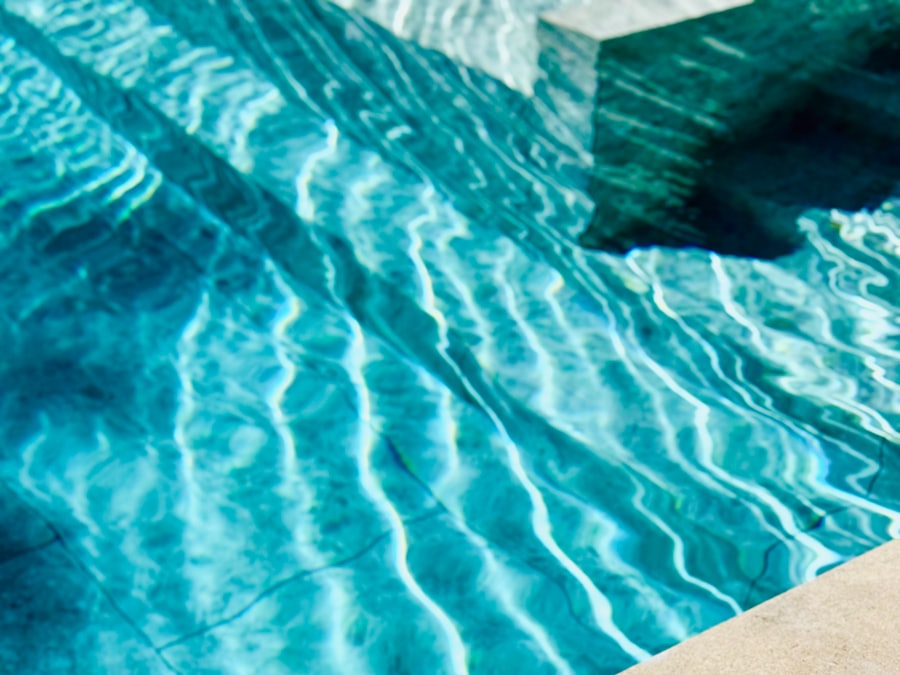 Bright sunlight scattering across the rippled surface of a swimming pool.